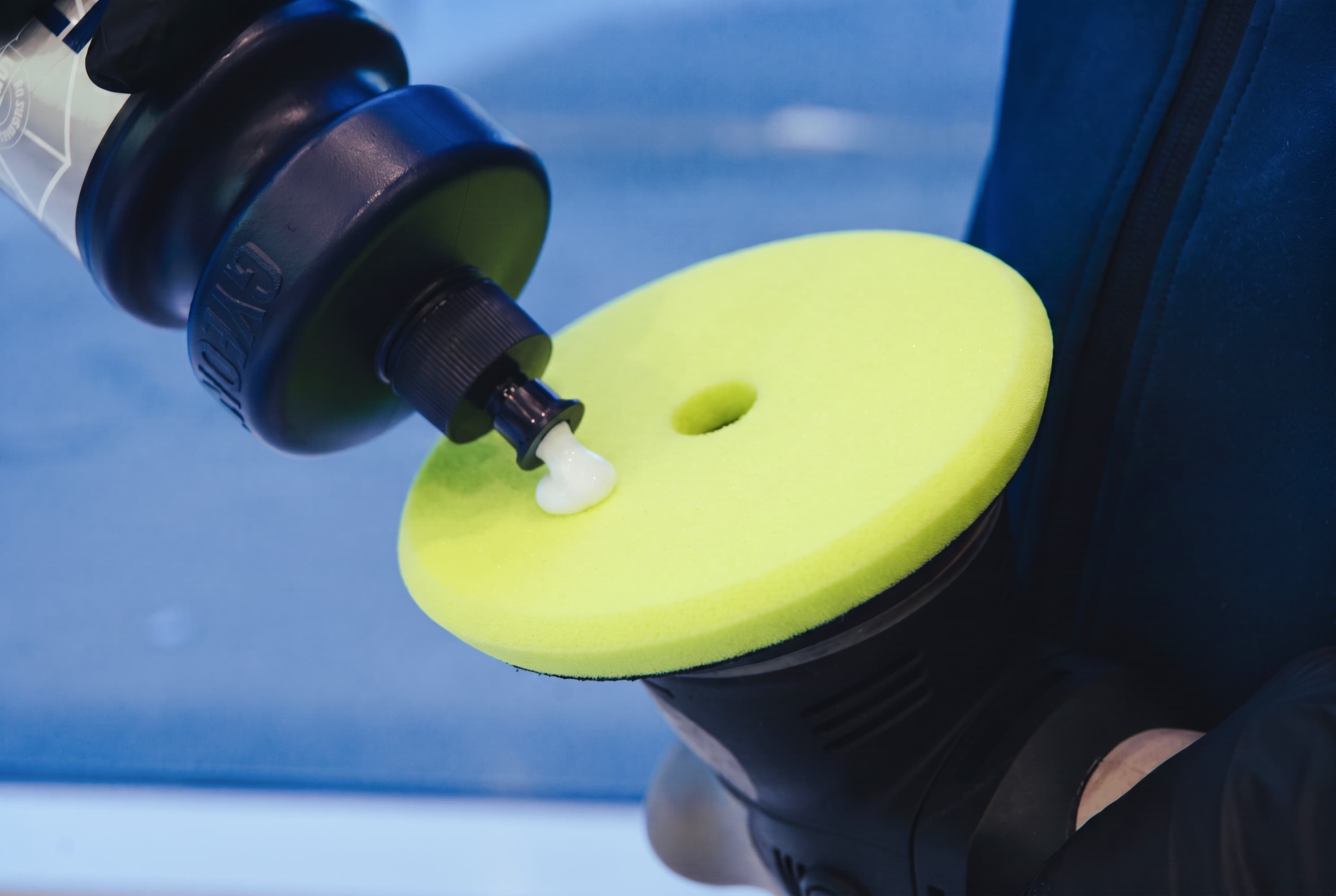 Polishing compound on a machine pad before paint correction