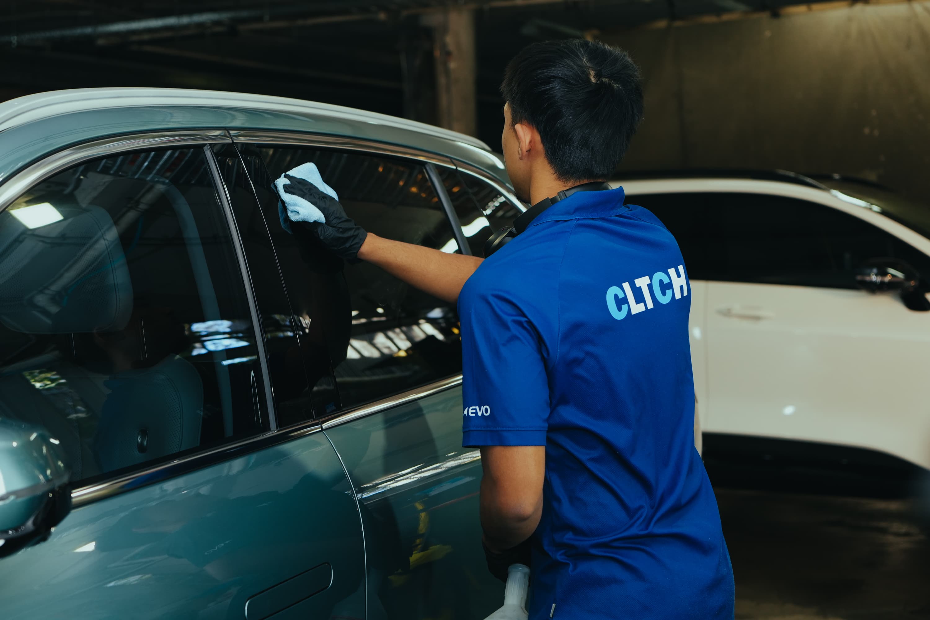 CLTCH technician detailing fleet vehicles in a depot