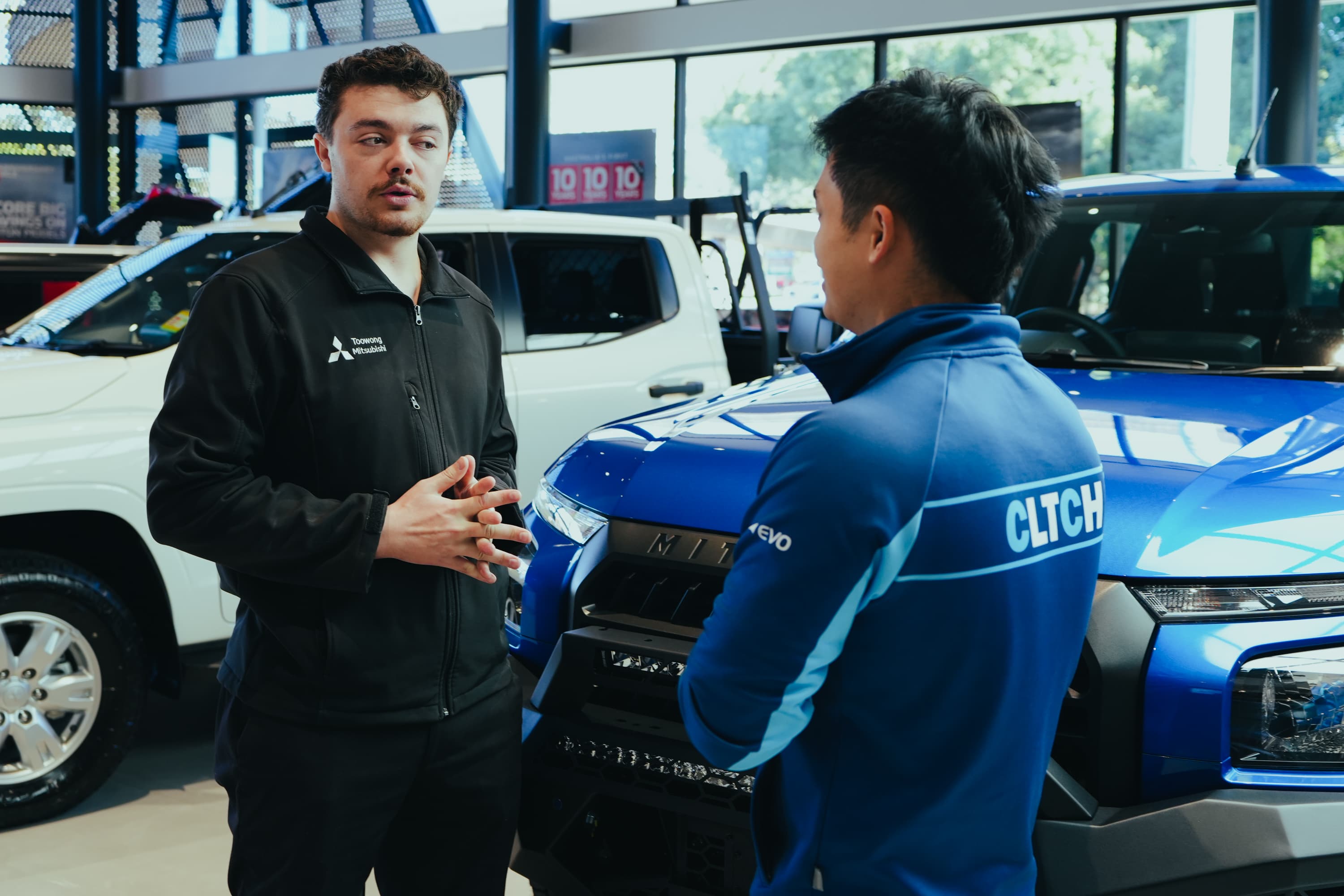 CLTCH account manager talking with dealership staff in the showroom