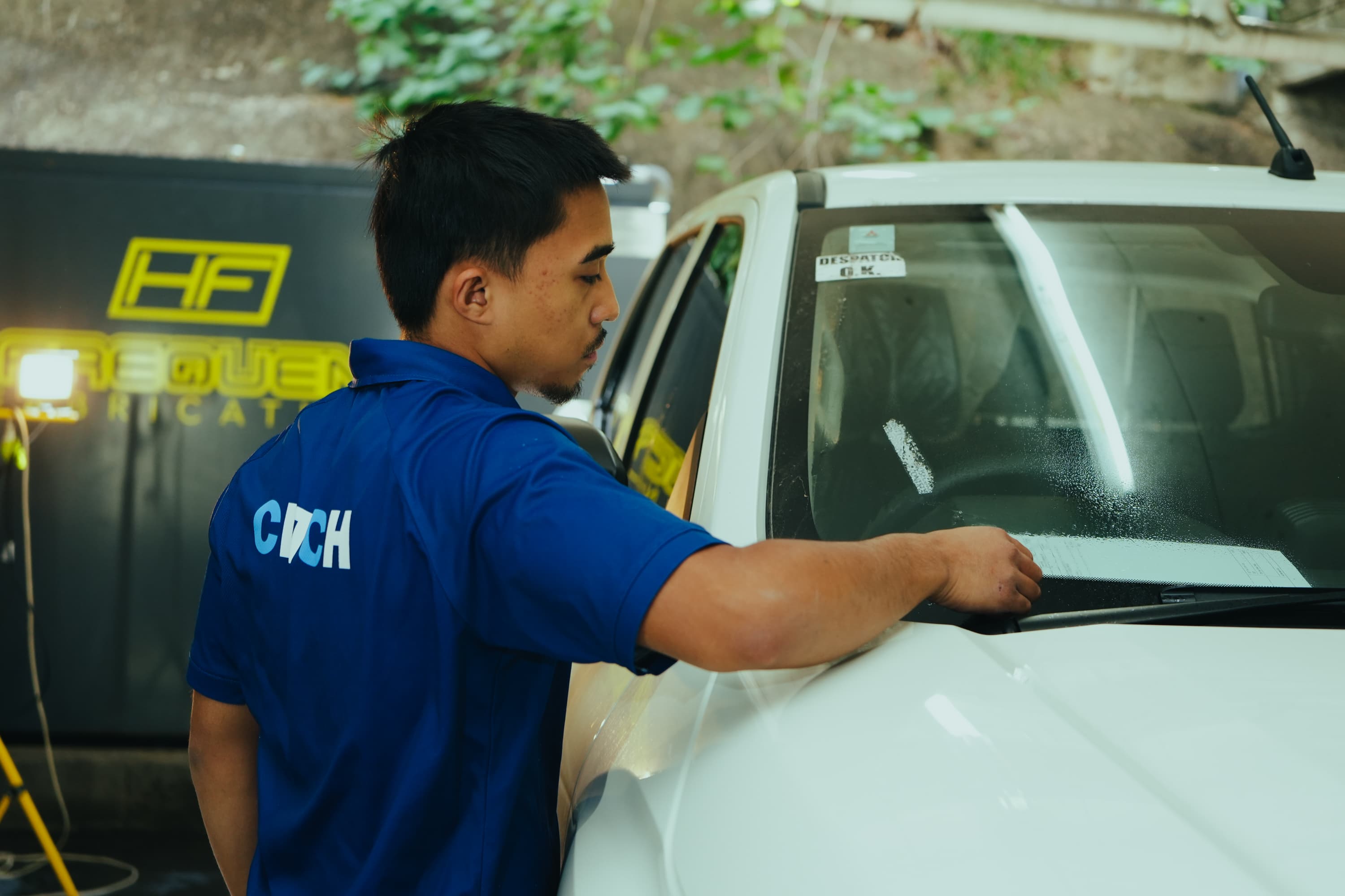 CLTCH technician checking despatch paperwork on prepared dealer stock